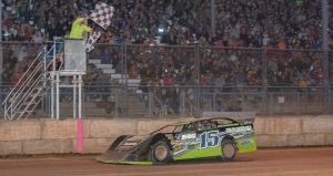 Nick Anvelink takes the checkered flags in front of an overflowing crowd after leading all 30 laps of the M.J. McBride Memorial at Shawano Speedway on April 16. (Shawn Fredenberg photo)
